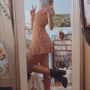 this is an orange and white flowery dress that is a tie around (adjustable)